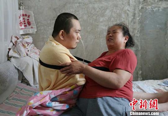 身體日漸衰老的梁青蘭每次幫兒子翻身、坐立，全身的衣物都要濕透一次?！∩忻鱾b 攝